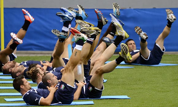 Italy's players stretch during a training session