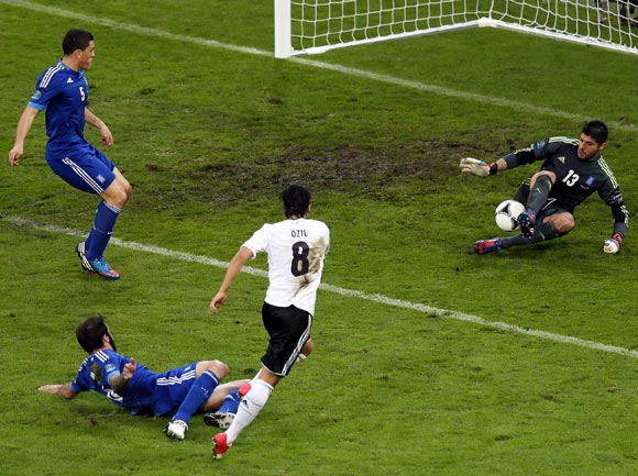 Mesut Oezil's shot is blocked by Greece's goalkeeper Michalis Sifakis