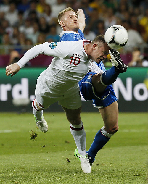 Italy's Ignazio Abate (left) challenges England's Wayne Rooney