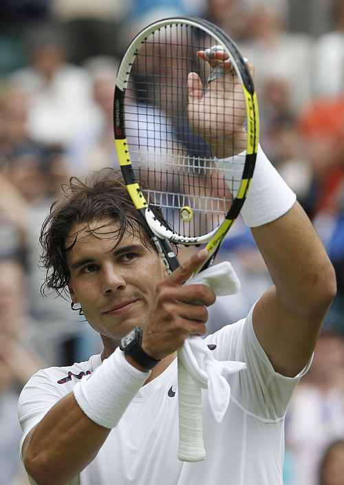 Rafael Nadal of Spain celebrates after defeating Thomaz Bellucci of Brazil in their men's singles tennis match at the Wimbledon tennis championships in London