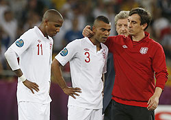 England's assistant coach Gary Neville (right) comforts England's Ashley Cole (2nd from left) and Ashley Young (left)