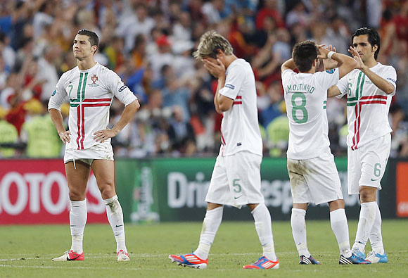Portugal's Cristiano Ronaldo, Fabio Coentrao, Joao Moutinho and Custodio react after losing to Spain