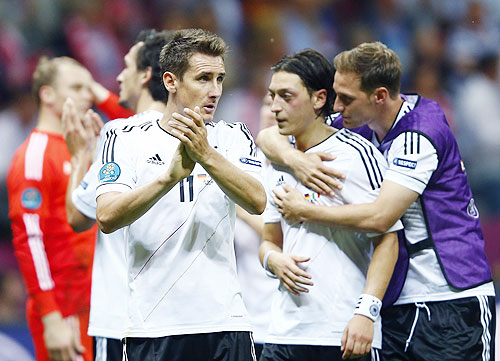Germany's Miroslav Klose (left) and Mesut Oezil react