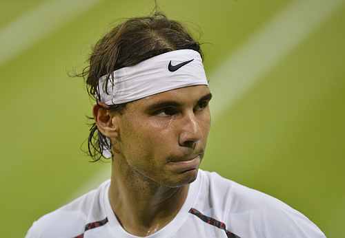 Rafael Nadal reacts in his men's singles match against Lukas Rosol at the Wimbledon