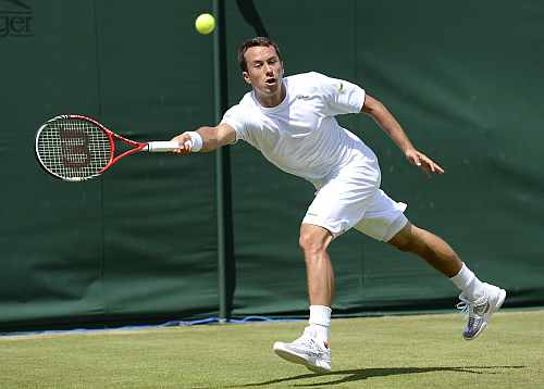 Philipp Kohlschreiber hits a return to Lukas Rosol during their men's singles match at the Wimbledon