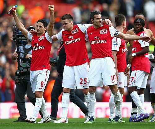 Arsenal players celebrate after winning a match