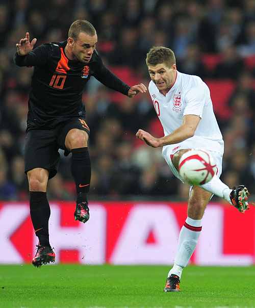 Steven Gerrard battles for the ball with Wesley Sneijder during the international friendly match