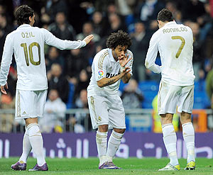 Real Madrid's Cristiano Ronaldo (right) celebrates with Marcelo and Mesut Ozil after scoring the opening goal against Espanyol on Sunday