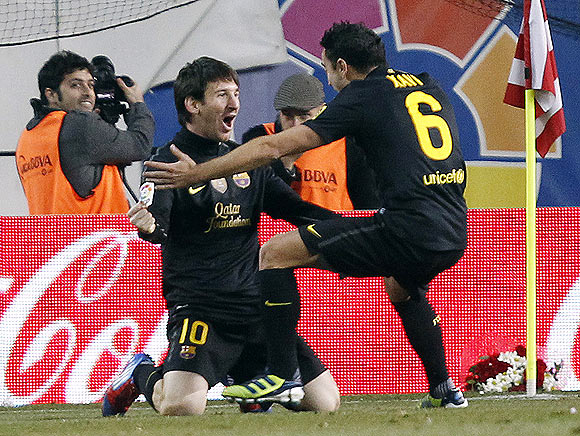 Barcelona's Lionel Messi celebrates with teammate Xavi