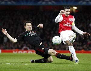 Arsenal striker Robin van Persie (right) is challenged by AC Milan's Mark van Bommel