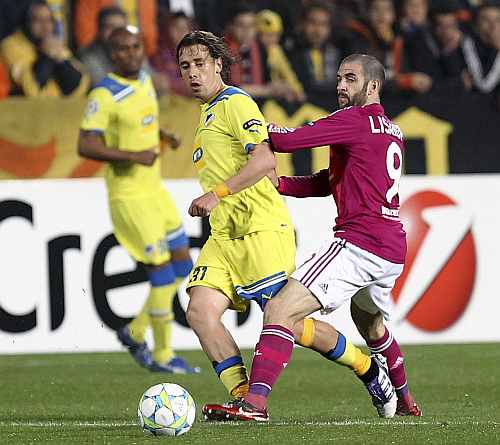 APOEL Nicosia's Helder Sousa challenges Olympique Lyon's Lyon Lisandro