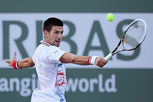 Novak Djokovic of Serbia returns a backhand to Andrey Golubev of Kazakhstan