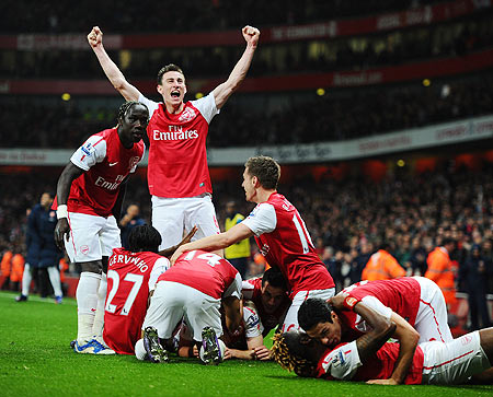 Arsenal players celebrate after Thomas Vermaelen of Arsenal scored their second goal