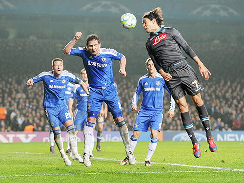 Frank Lampard of Chelsea and Edinson Cavani of Napoli jump for the ball during the UEFA Champions League