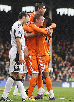 Swansea's Gylfi Sigurdsson (2nd from right) is congratulated by team-mates after scoring against Fulham on Saturday