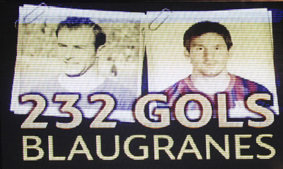 The video scoreboard displays the number of goals scored by Lionel Messi (right) and FC Barcelona player Cesar following Messi's record-equalling goal against Granada on Tuesday