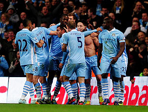 Manchester City's Samir Nasri (shirtless) is congratulated by teammates after scoring his team's second goal during their EPL match against Chelsea on Wednesday