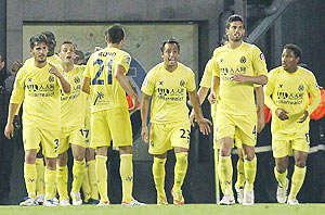 Villarreal's players celebrate after scoring against Real Madrid during their La Liga match on Wednesday