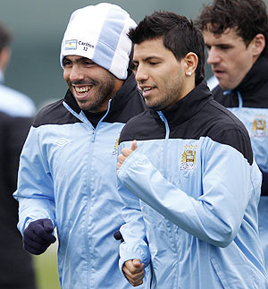 Manchester City's Carlos Tevez (left) with Sergio Aguero (centre) during a training session