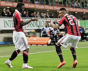 AC Milan's Sulley Muntari (left) and teammate Kevin-Prince Boateng break into a jig after the former scored against Atalanta during their Serie A match on Wednesday