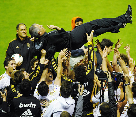Real Madrid's coach Jose Mourinho is thrown into the air by his players after their win over Athletic Bilbao to clinch the La Liga title on Wednesday