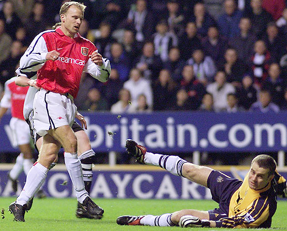 Newcastle United's Shay Given (right) tries to stop Arsenal's Dennis Bergkamp (left) from scoring during their English Premier League match at St James's Park, on March 2, 2002