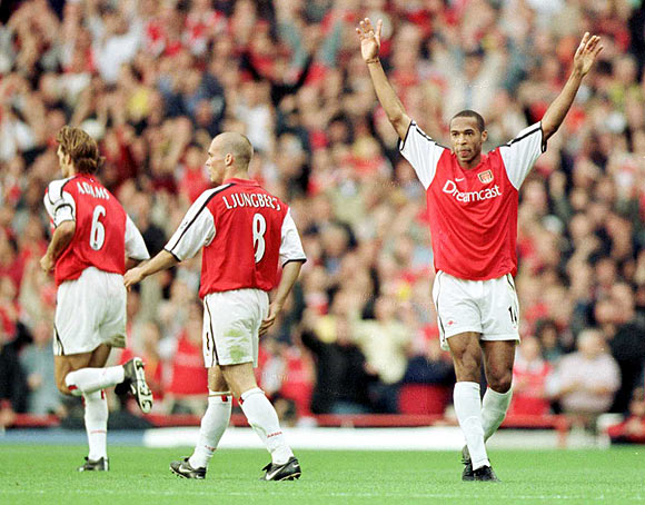 Arsenal's Thierry Henry (right) celebrates after scoring against Manchester United on October 1 2000