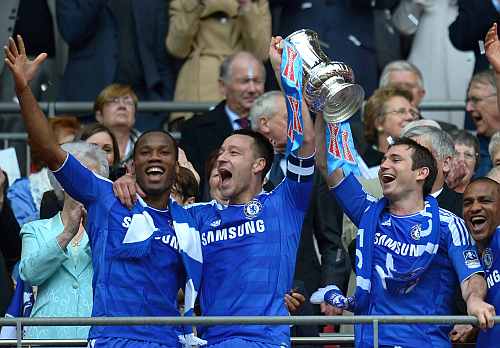 Didier Drogba, John Terry, Frank Lampard of Chelsea lift the FA Cup trophy after beating Liverpool at Wembley