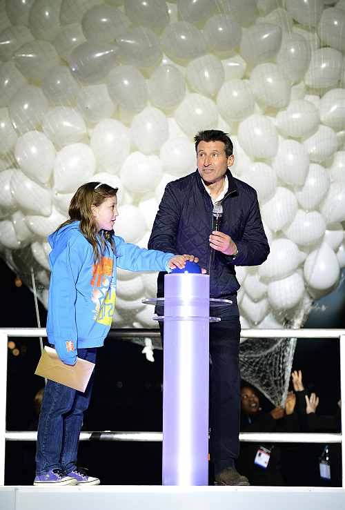 Sebastian Coe and local resident Niamh Clarke-Willis press a button to officially open the Olympic Stadium inside the Olympic Park in London
