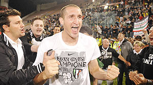 Juventus' Giorgio Chiellini celebrates with fans after winning the Italian Serie A title at the end of the match against Cagliari at the Nereo Rocco stadium in Trieste on Sunday