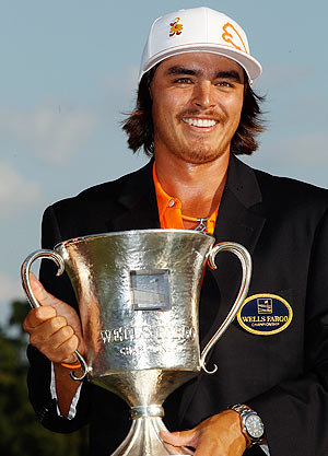 Rickie Fowler of the United States celebrates with the Quail Hollow championship trophy after defeating Rory McIlroy of Northern Ireland and DA Points of the United States in a playoff