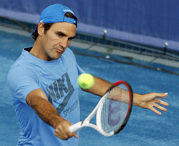 Roger Federer of Switzerland returns the ball during a training session at the Madrid Open