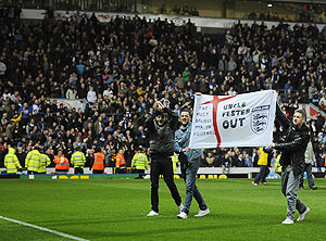 Blackburn Rovers' fans protest on the pitch after their EPL match against Wigan Athletic in Blackburn, on Monday