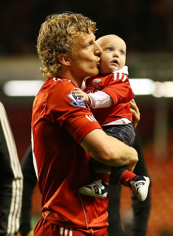 Liverpool's Dirk Kuyt celebrates with his kid after the victory against Chelsea on Tuesday