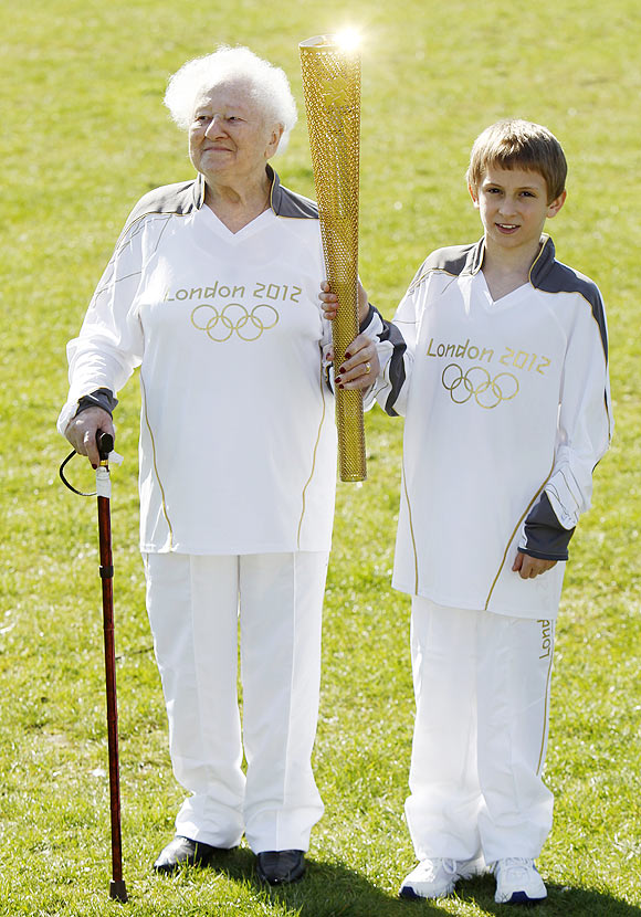 The Oldest Olympic torch bearer for the London 2012 Olympic Games, Dinah Gould (left) who will be 100 when she carries the flame, and the youngest, 11 year old Dominic John MacGowan, pose with an Olympic torch