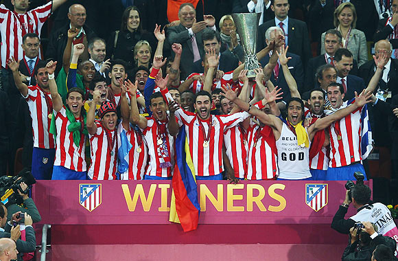 Atletico Madrid players celebrate with the trophy afer defeating Athletic Bilbao in  their UEFA Europa League final on Wednesday