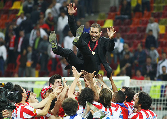 Atletico Madrid Coach Diego Simeone is thrown in the air by his players after winning the Europa League final on Wednesday