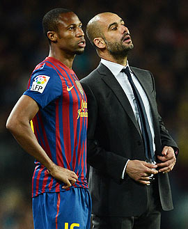 Head coach Josep Guardiola (right) of FC Barcelona follows the game as he brings on Seydou Keita