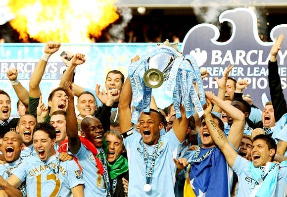 Manchester City players celebrate winning the English Premier League