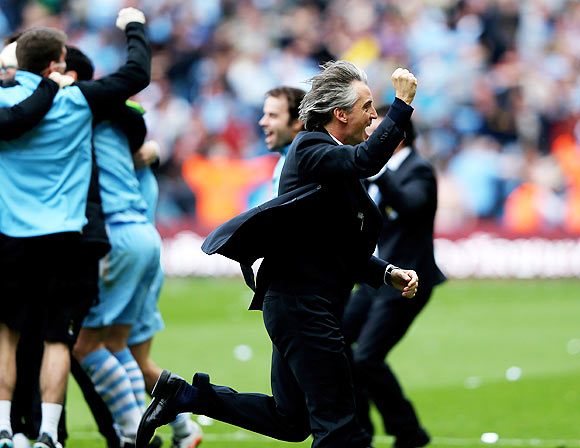 Roberto Mancini the manager of Manchester City celebrates