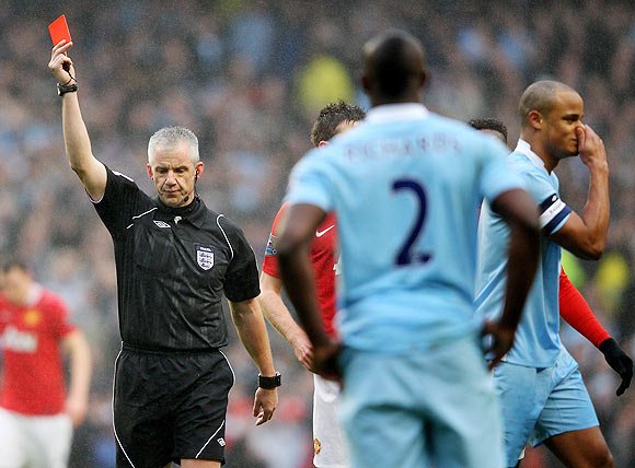 Referee Chris Foy sends off Vincent Kompany of Manchester City