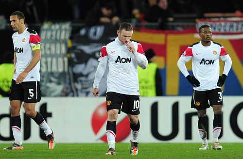 Manchester United players walk off the pitch after their loss against FC Basel