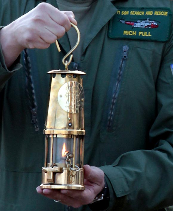 Lieutenant commander Richie Full delivers the Olympic Flame from RNAS Culdrose at Lands End