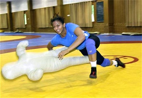 Wrestler Geeta Phogat practises using a training dummy at the Netaji Subhas National Institute of Sports in Patiala