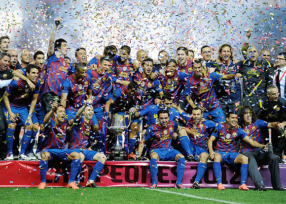 Barcelona players celebrate with the Copa del Rey trophy after beating Athletic Bilbao 3-0 on Friday