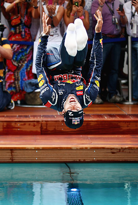 Mark Webber of Red Bull Racing celebrates winning the race by jumping into the swimming pool on the Red Bull Energy Station following the Monaco Formula One Grand Prix