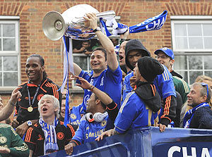 Chelsea's Frank Lampard (centre) holds the Champions League trophy near owner Roman Abramovich (right) during their victory parade in west London
