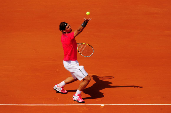 Rafael Nadal of Spain serves in his men's singles first round match against Simone Bolelli of Italy during day 3 of the French Open at Roland Garros