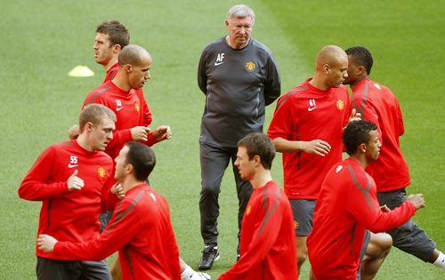 Manchester United manager Ferguson watches his players during training