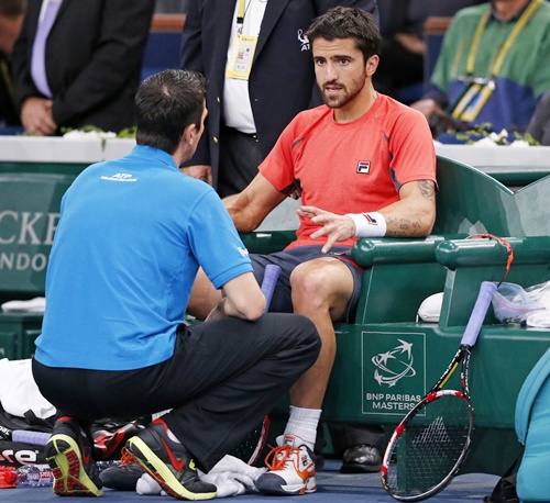 Janko Tipsarevic of Serbia receives medical attention